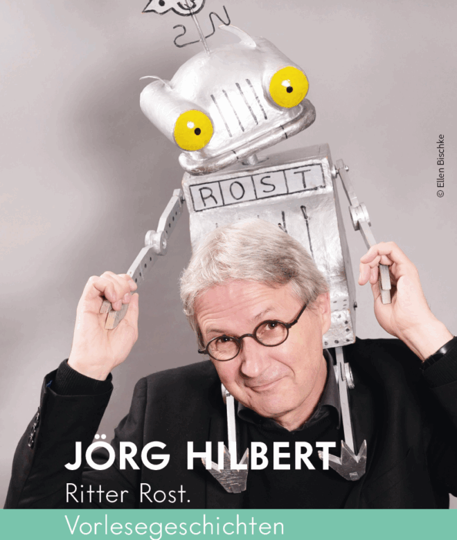 Kinderbuchautor Jörg Hilbert mit einer Theaterpuppe von Ritter Rost auf Jörg Hilberts Schultern sitzend